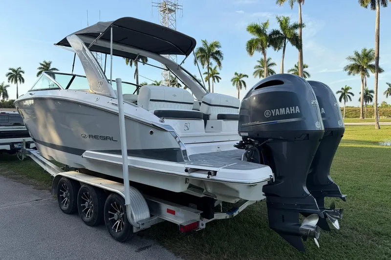 Slide: The Image of 2021 Regal 29 OBX boat with twin Yamaha outboard engines on a trailer. - 4