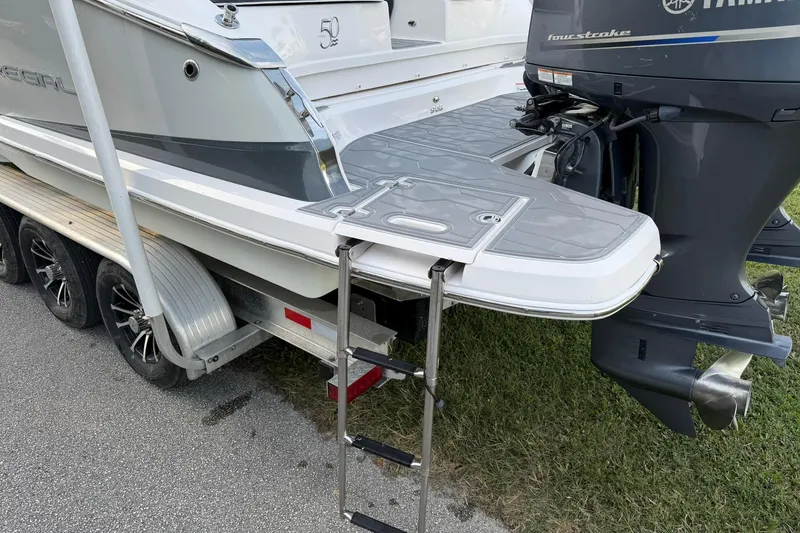 Slide: The Image of 2021 Regal 29 OBX boat on trailer with Yamaha outboard motor and swim platform. - 9