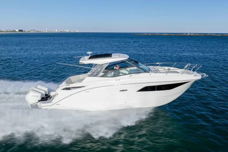 Slide: The Image of 2020 Sea Ray Sundancer 320 Outboard cruising on open water. - 10