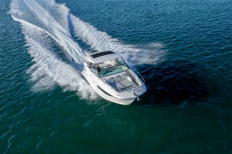 Slide: The Image of 2020 Sea Ray Sundancer 320 Outboard cruising on open water, aerial view. - 12