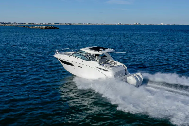 Slide: The Image of 2020 Sea Ray Sundancer 320 Outboard cruising on open water. - 17