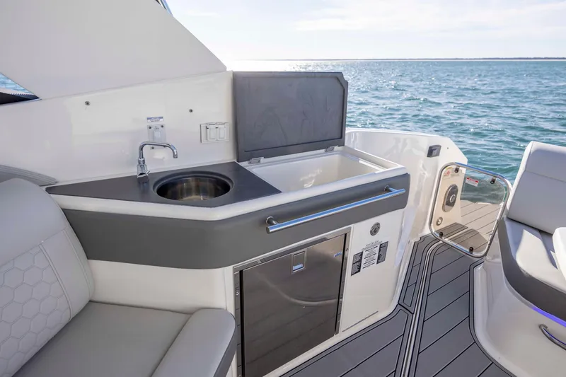 Slide: The Image of 2020 Sea Ray Sundancer 320 Outboard interior with kitchenette and ocean view. - 21