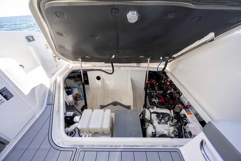 Slide: The Image of 2020 Sea Ray Sundancer 320 Outboard engine compartment with open hatch, showcasing internal components. - 23