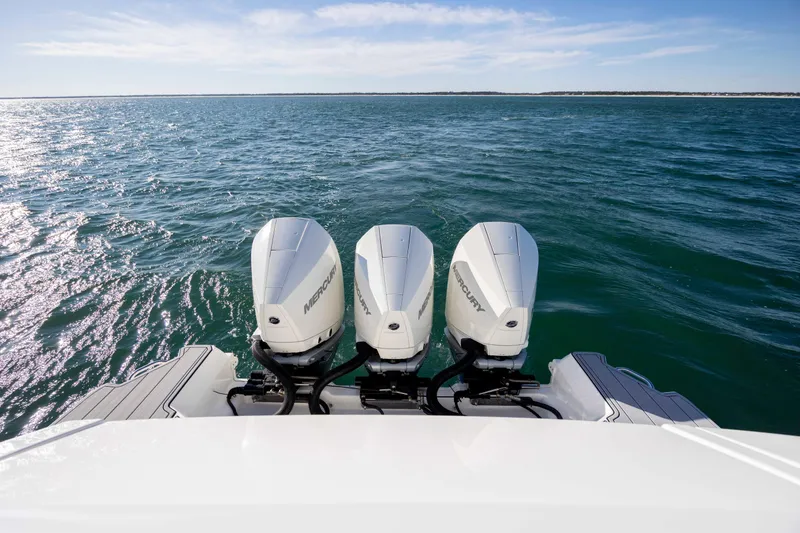 Slide: The Image of 2020 Sea Ray Sundancer 320 Outboard with triple Mercury engines on open water. - 28