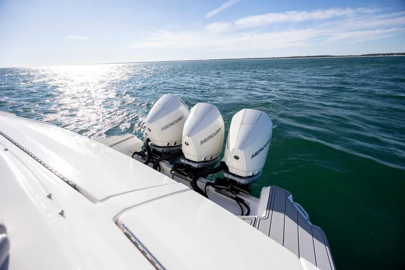 Slide: The Image of 2020 Sea Ray Sundancer 320 Outboard with triple Mercury engines on open water. - 29