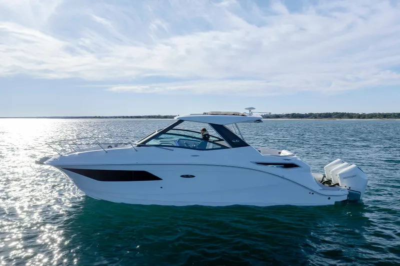 Slide: The Image of 2020 Sea Ray Sundancer 320 Outboard cruising on open water under a clear sky. - 3