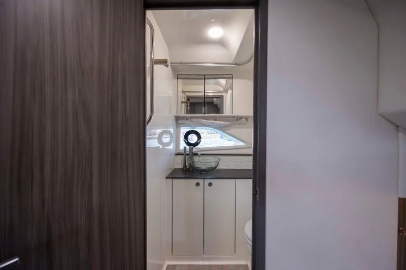 Slide: The Image of 2020 Sea Ray Sundancer 320 Outboard bathroom interior with modern fixtures and wood accents. - 40
