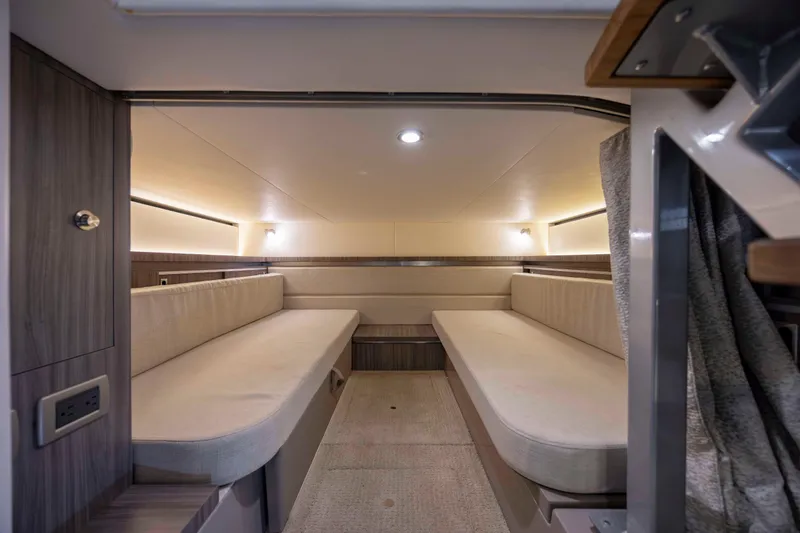 Slide: The Image of 2020 Sea Ray Sundancer 320 Outboard cabin interior with twin seating and modern lighting. - 41