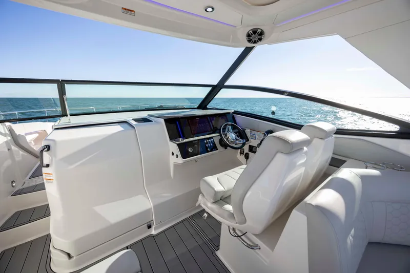 Slide: The Image of 2020 Sea Ray Sundancer 320 Outboard helm with modern controls and ocean view. - 43