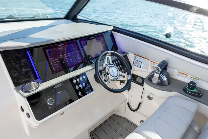 Slide: The Image of Cockpit of 2020 Sea Ray Sundancer 320 Outboard with modern controls and navigation displays. - 44