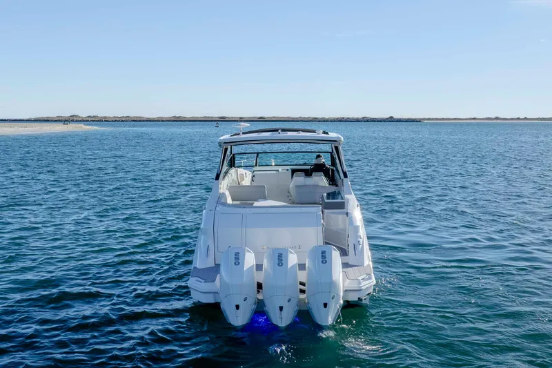 Slide: The Image of 2020 Sea Ray Sundancer 320 Outboard cruising on open water, rear view. - 5