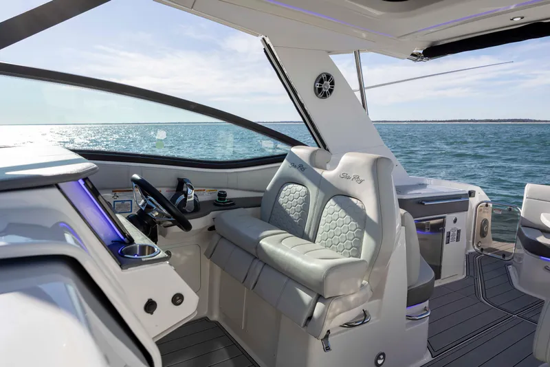Slide: The Image of 2020 Sea Ray Sundancer 320 Outboard cockpit with luxurious seating and ocean view. - 50