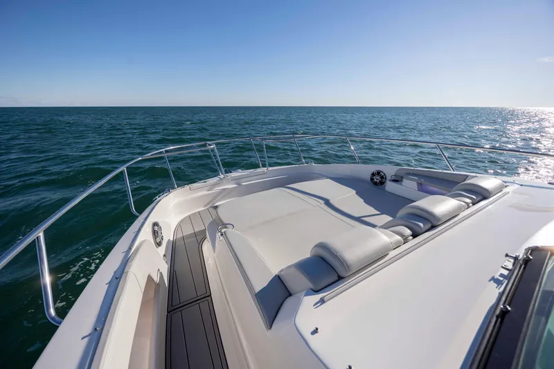 Slide: The Image of 2020 Sea Ray Sundancer 320 Outboard cruising on open water, featuring spacious deck seating. - 51