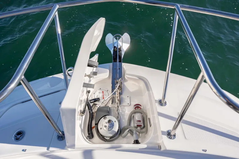Slide: The Image of 2020 Sea Ray Sundancer 320 Outboard anchor system on deck, surrounded by stainless steel railings. - 52