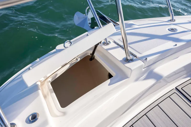 Slide: The Image of 2020 Sea Ray Sundancer 320 Outboard boat storage compartment open on deck. - 53