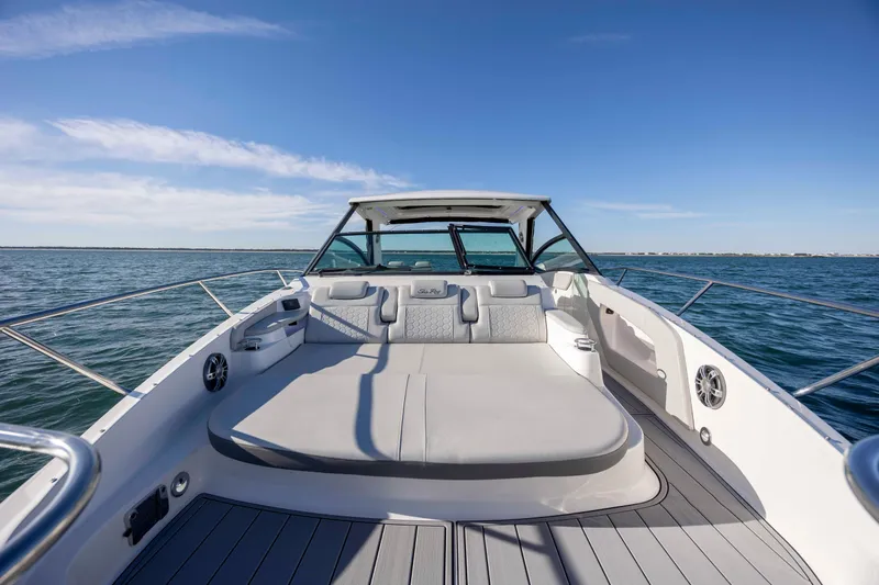 Slide: The Image of 2020 Sea Ray Sundancer 320 Outboard on open water, showcasing spacious deck and seating. - 55