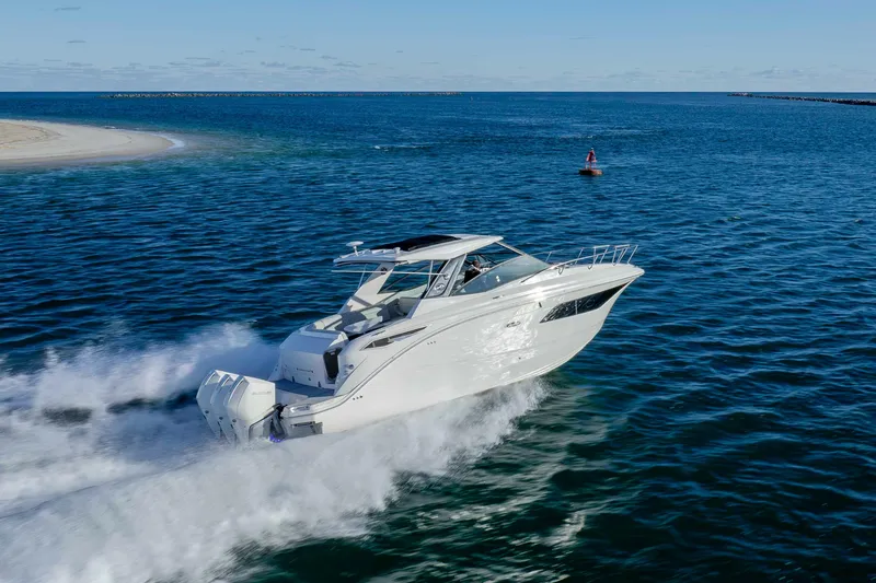 Slide: The Image of 2020 Sea Ray Sundancer 320 Outboard cruising on open water, showcasing sleek design. - 8