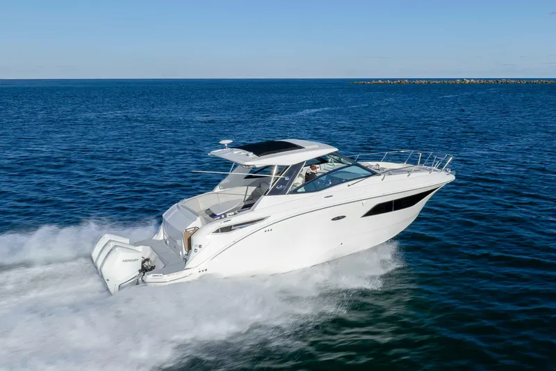 Slide: The Image of 2020 Sea Ray Sundancer 320 Outboard cruising on open water, showcasing sleek design and performance. - 9