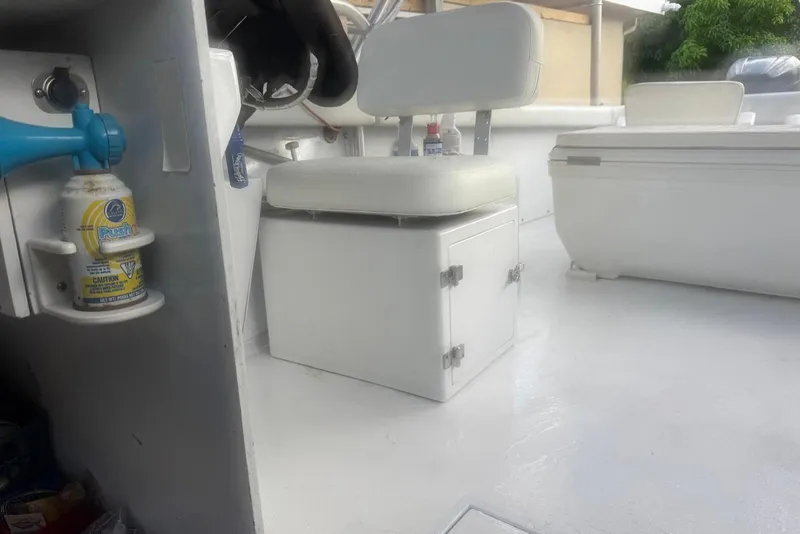 Slide: The Image of Interior of a 1962 Bertram 25 Moppie boat with white seating and storage. - 5