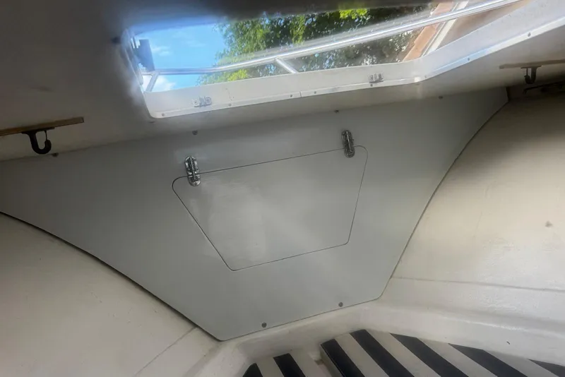 Slide: The Image of Interior view of a 1962 Bertram 25 Moppie boat cabin with a hatch and window. - 6