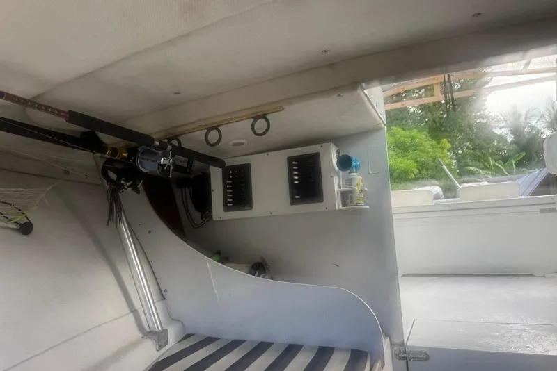 Slide: The Image of Interior of a 1962 Bertram 25 boat with fishing rods. - 7