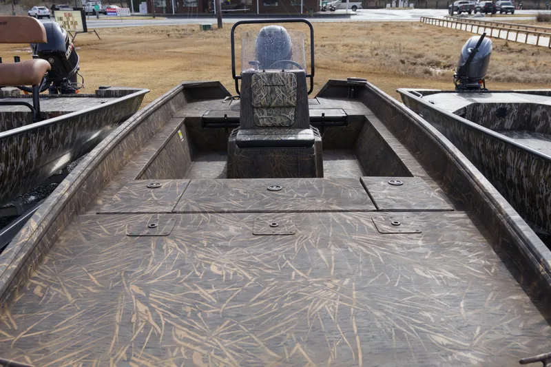 Slide: The Image of 2026 G3 Gator Tough 20 CC boat with camo design, parked outdoors. - 7