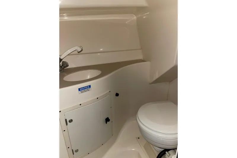 Slide: The Image of Interior of 2002 Pursuit 2860 Denali boat with wooden steps and compact kitchen area. - 10