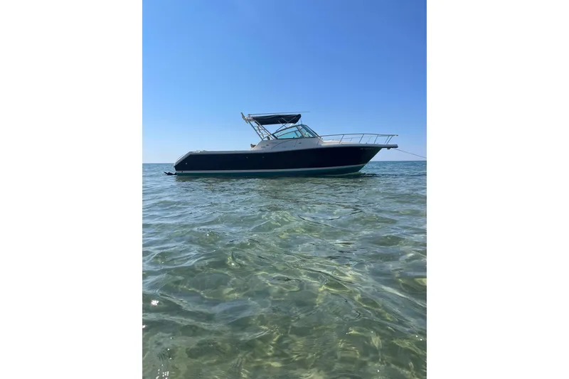 Slide: The Image of 2002 Pursuit 2860 Denali boat dashboard with steering wheel and navigation instruments. - 3