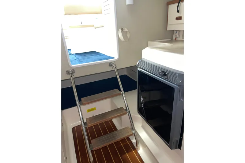 Slide: The Image of 2002 Pursuit 2860 Denali boat on clear water under blue sky. - 8