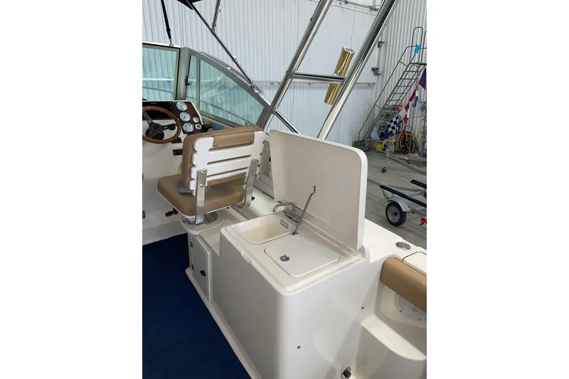 Slide: The Image of 2002 Pursuit 2860 Denali boat anchored in clear blue water under a sunny sky. - 9