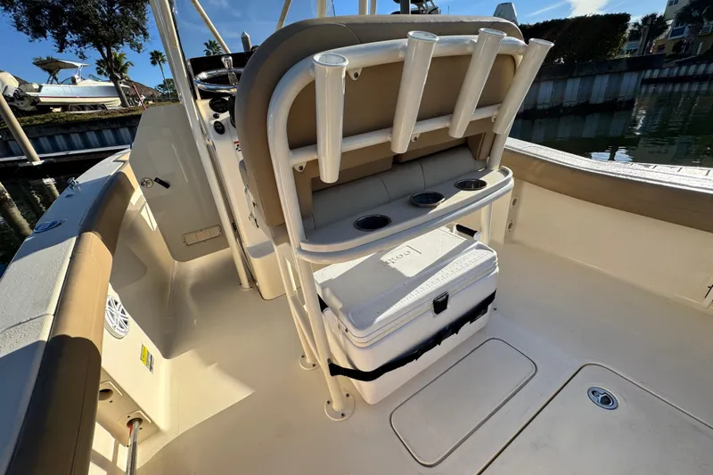 Slide: The Image of 2022 Scout 215 XSF boat interior with rod holders and cooler. - 14