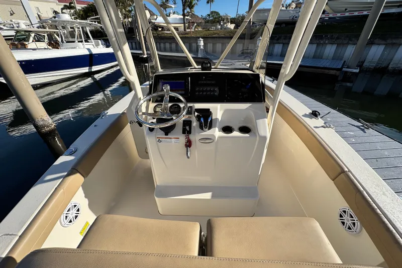 Slide: The Image of 2022 Scout 215 XSF boat interior with steering wheel and control panel. - 16