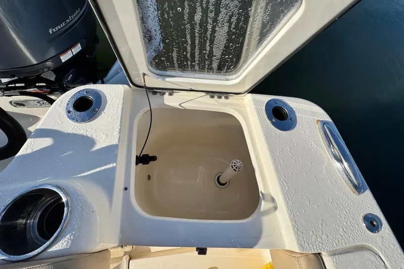 Slide: The Image of Open storage compartment on a 2022 Scout 215 XSF boat. - 25