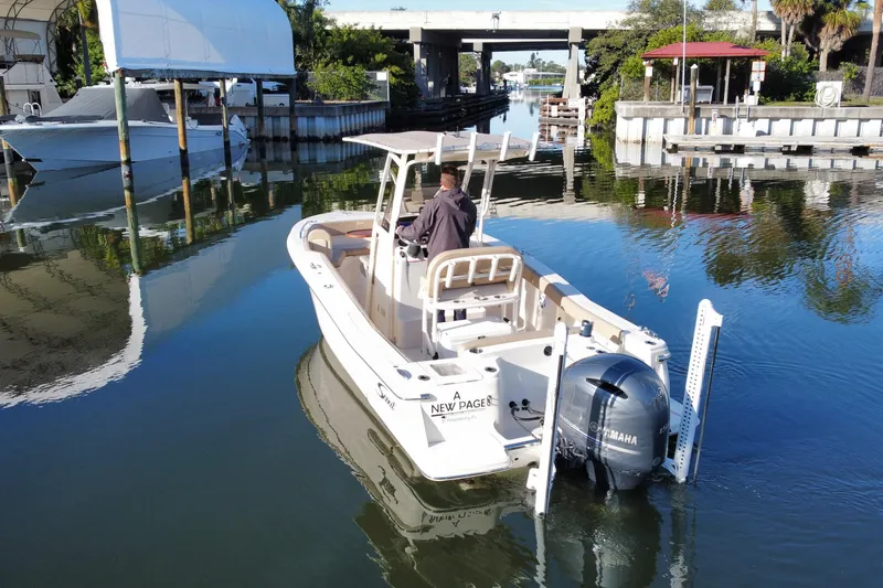 Slide: The Image of 2022 Scout 215 XSF boat navigating a calm waterway with Yamaha outboard motor. - 3