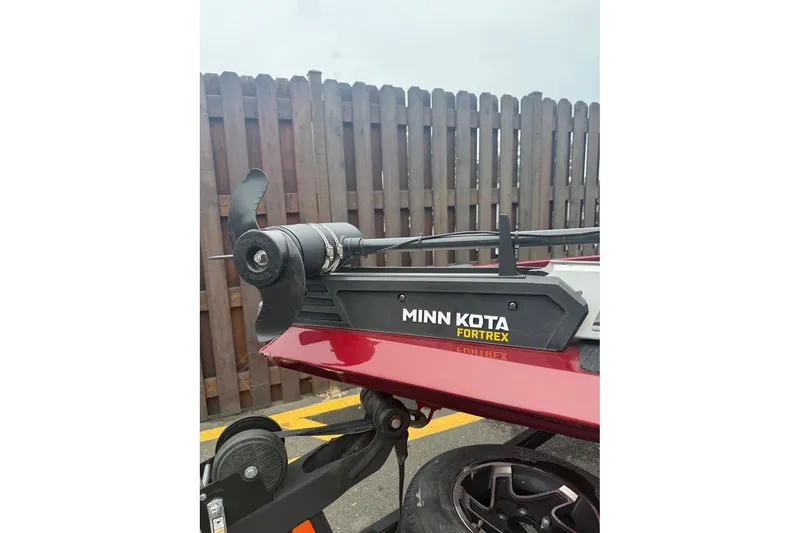 Slide: The Image of 2020 Ranger RT188 boat with Minn Kota Fortrex trolling motor, parked near a wooden fence. - 7