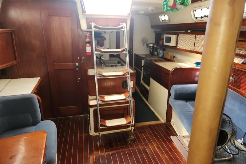 Slide: The Image of Interior of 1993 Catalina Morgan 381 sailboat with wooden finishes and cozy seating. - 13