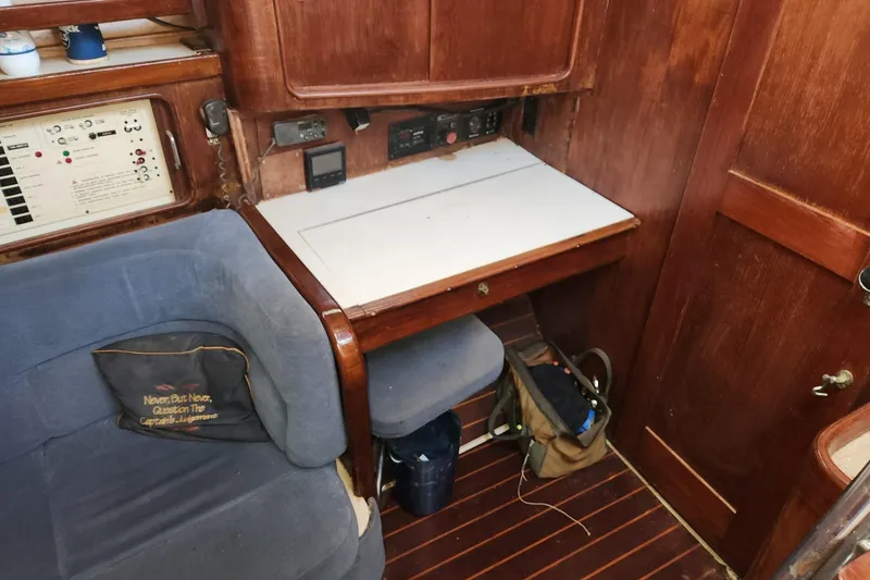 Slide: The Image of Interior of 1993 Catalina Morgan 381 sailboat with navigation station and seating area. - 15