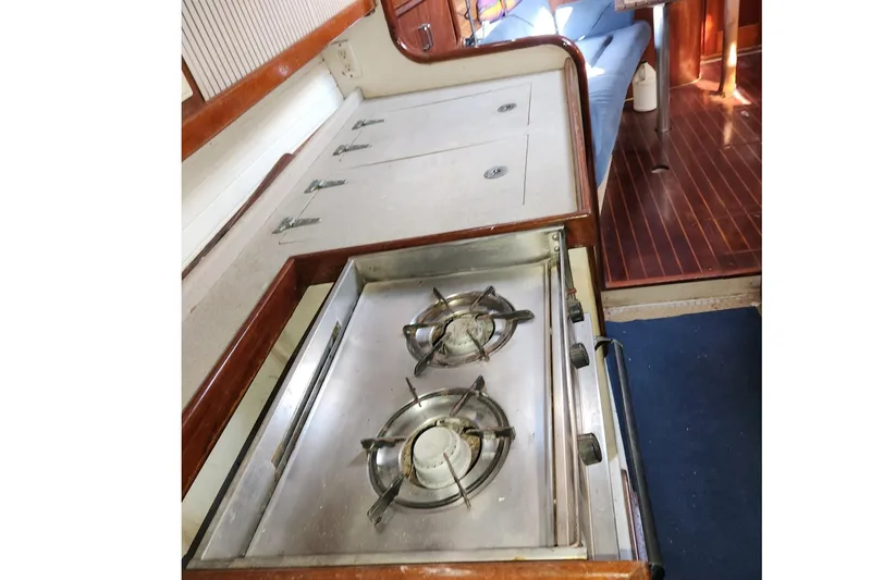 Slide: The Image of 1993 Catalina Morgan 381 yacht kitchen with stove and wooden interior. - 18