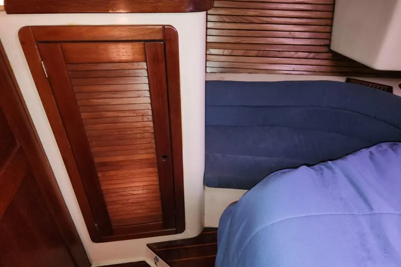 Slide: The Image of 1993 Catalina Morgan 381 interior with wooden door and blue seating. - 22