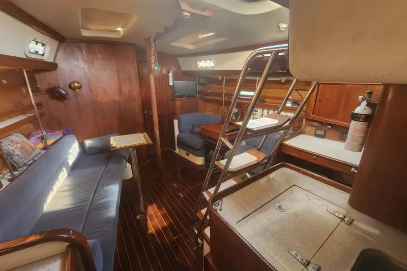Slide: The Image of Interior of 1993 Catalina Morgan 381 sailboat with wooden finishes and blue seating. - 7