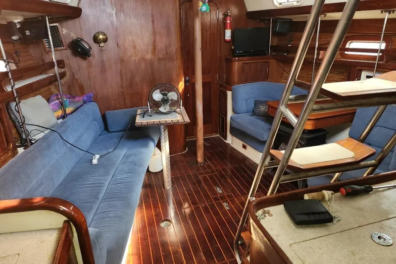Slide: The Image of Interior of 1993 Catalina Morgan 381 sailboat with blue seating and wooden accents. - 9