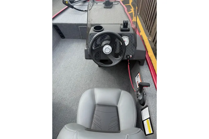 Slide: The Image of 2023 Tracker Bass Tracker Classic XL boat interior with steering wheel and seat. - 2