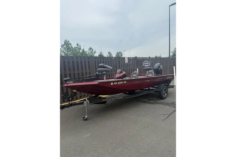 The Image of 2021 Ranger RT178 boat in red on a trailer, parked outdoors. - 0