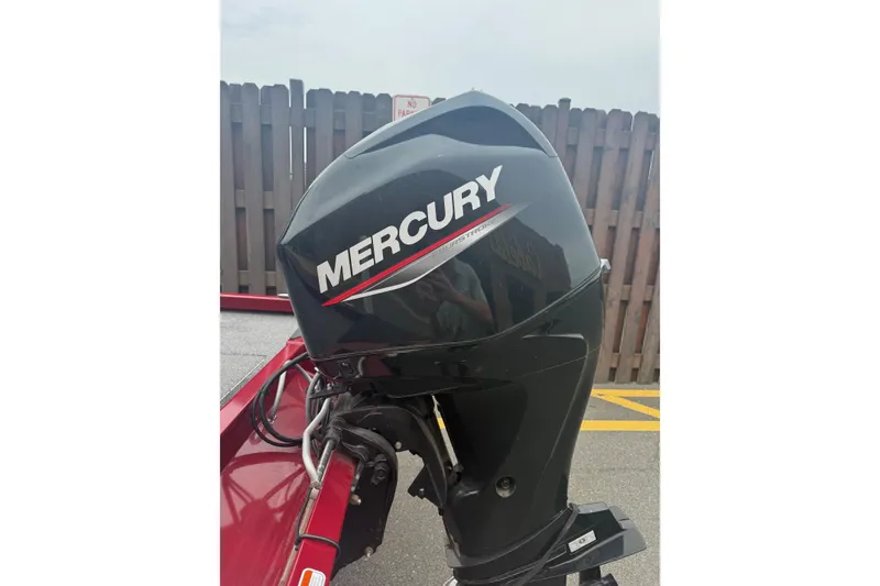 Slide: The Image of Mercury outboard motor on 2021 Ranger RT178 boat, parked near wooden fence. - 5