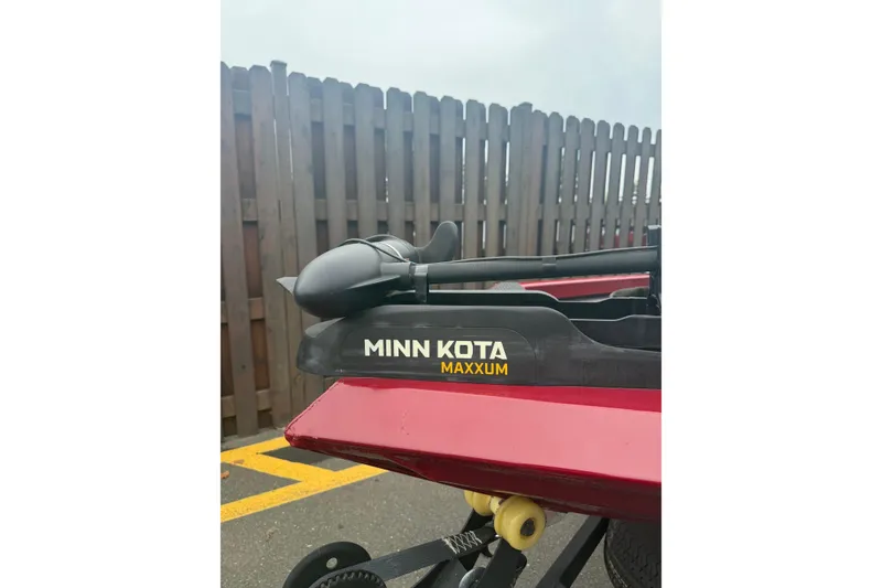 Slide: The Image of 2021 Ranger RT178 with Minn Kota Maxxum trolling motor, parked near a wooden fence. - 8