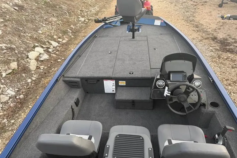 Slide: The Image of 2026 Lowe Stinger 195 Bass boat interior with steering console and seating. - 11