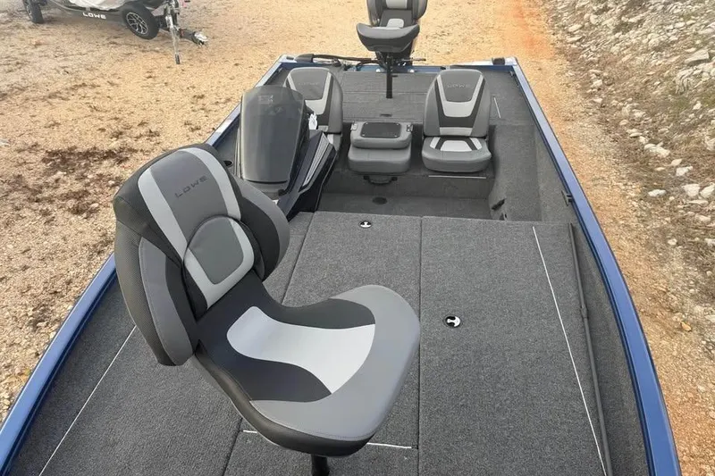 Slide: The Image of 2026 Lowe Stinger 195 Bass boat interior with gray seating and carpeted deck. - 14