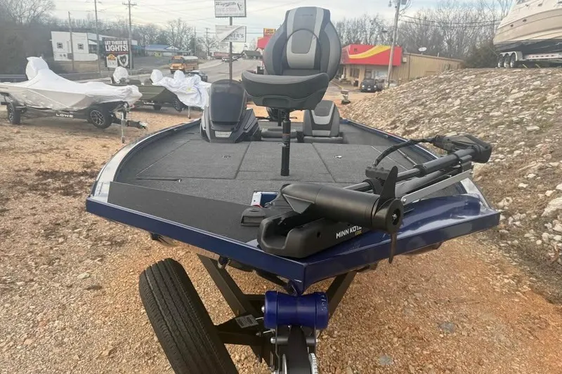 Slide: The Image of 2026 Lowe Stinger 195 Bass boat with trolling motor and elevated seat on display. - 2