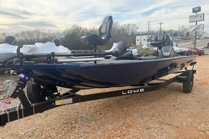 Slide: The Image of 2026 Lowe Stinger 195 Bass boat on trailer, parked outdoors. - 3