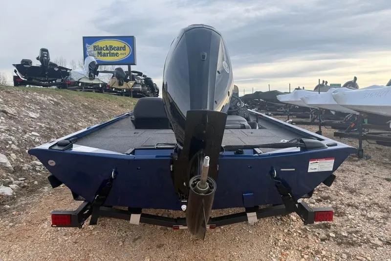 Slide: The Image of 2026 Lowe Stinger 195 Bass boat with outboard motor at BlackBeard Marine dealership. - 5